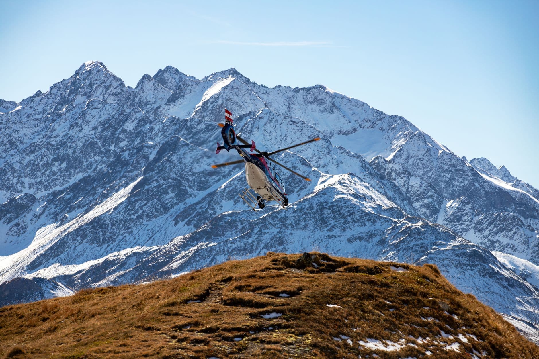 A helicopter working a high alpine ridge in Western Canada.